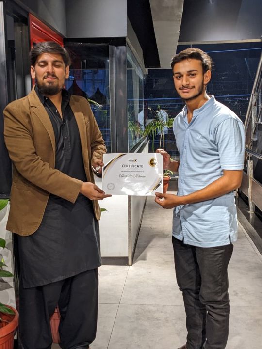 A Saapx developer receiving the Best Performer Award certificate