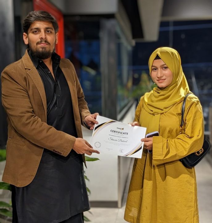 A Saapx team member receiving a certificate of appreciation