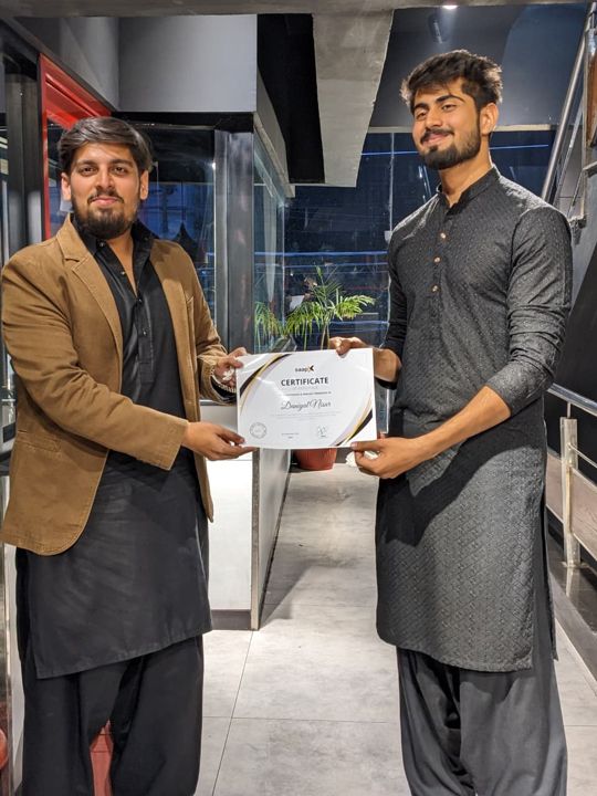 A Saapx engineer receiving a certificate of appreciation
